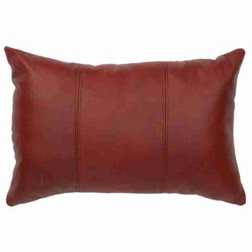 Red leather cowhide decorative pillow by wooded river